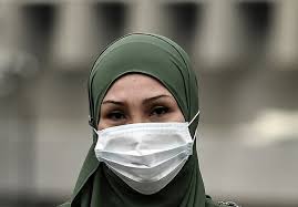 Woman wearing a hijab and face mask